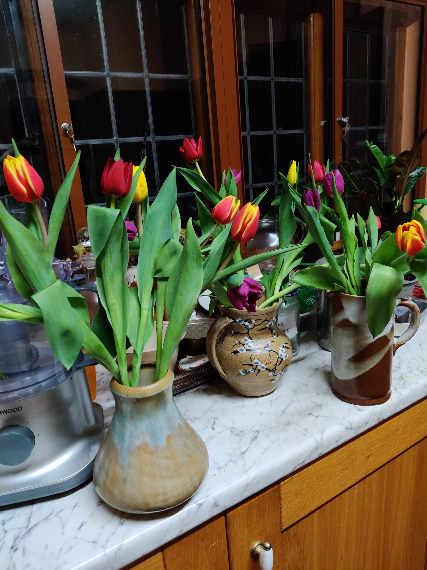 vases of flowers by a window